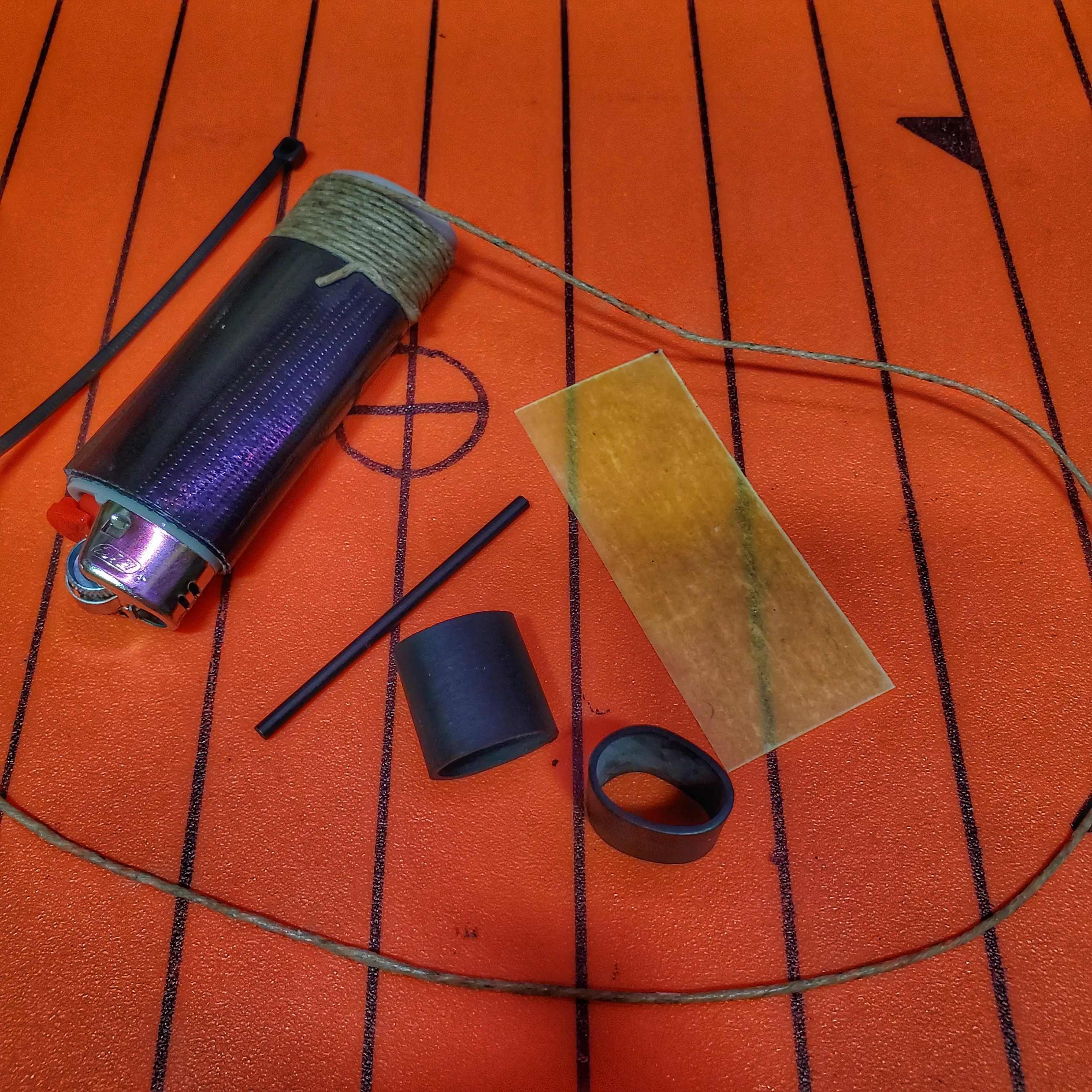 Survival Kit Lighter - Fire Starter outfitted with supplies.